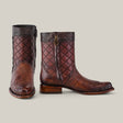 The Exotic American Alligator boots in Europe Fawn exude refined style with a quilted diamond pattern and reptile texture. They feature side zippers, dark top trim, and decorative stitching, all set against a plain light gray background.