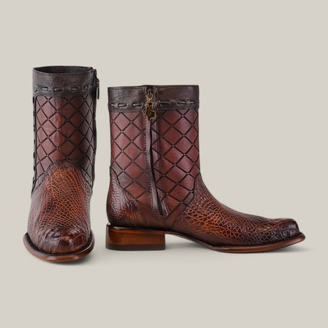 The Exotic American Alligator boots in Europe Fawn exude refined style with a quilted diamond pattern and reptile texture. They feature side zippers, dark top trim, and decorative stitching, all set against a plain light gray background.