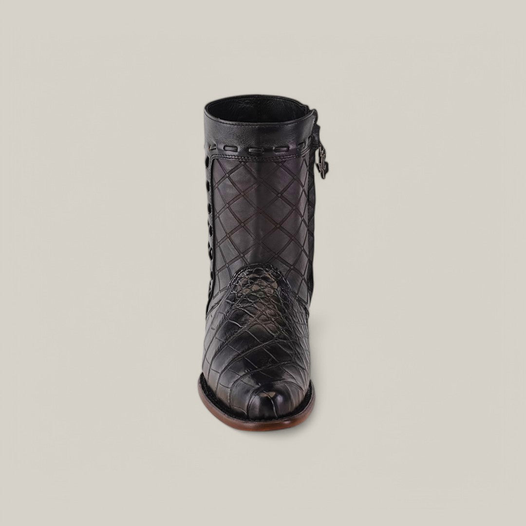 The Exotic American Alligator boot in Europe Black features a quilted texture and detailed stitching with a side zipper and decorative metal accents. This European design showcases a round toe and low heel, set against a plain grey background.