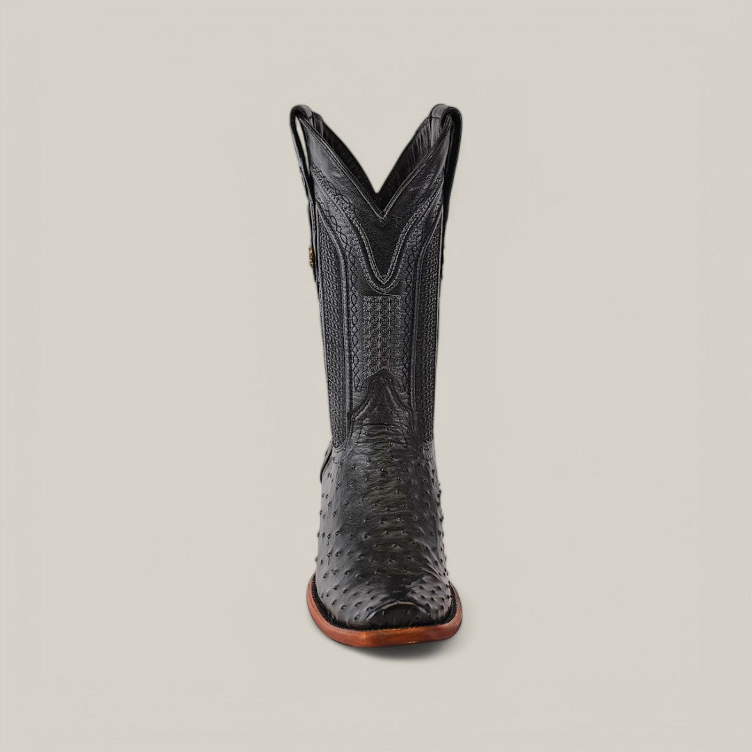 The Exotic Ostrich black cowboy boot with a narrow square toe, crafted from genuine ostrich leather and a detailed shaft pattern, stands against a light gray background. The design highlights Western heritage with its brown sole.