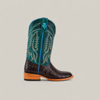 The Exotic Caiman Horn Back - Dark Brown - Square Toe boot features a dark brown caiman leather foot, tall teal shaft with yellow stitching, and a wooden heel, shown on a plain light background.