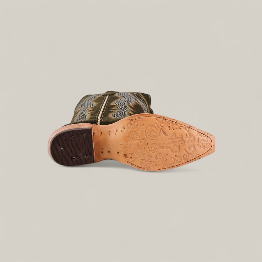 The Della Olive Green - Tall Shaft - Snip Toe cowboy boot is shown on its side, sole up to reveal floral engravings on the light tan leather and heel. The olive green upper features decorative stitching.