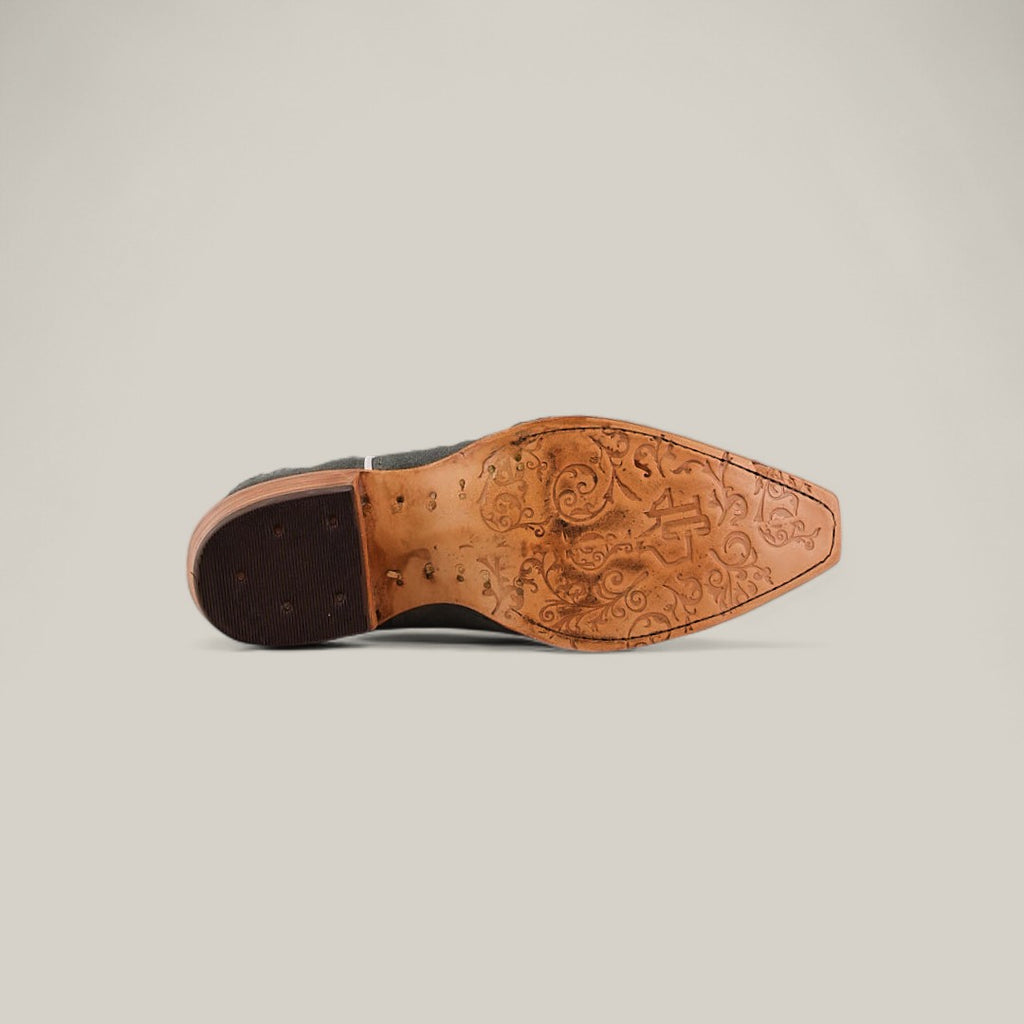 The image shows the sole of the Celine Gray - Tall Shaft - Snip Toe, featuring intricate decorative engravings on the leather, reminiscent of fine womens boots craftsmanship, viewed from below against a plain light background.