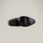 The Kellie Clayton Caramel Leather Sole boot features a tall shaft, snip toe, visible stitching, and is shown from the sole with TEXAS COUNTRY and a logo imprinted on the bottom.