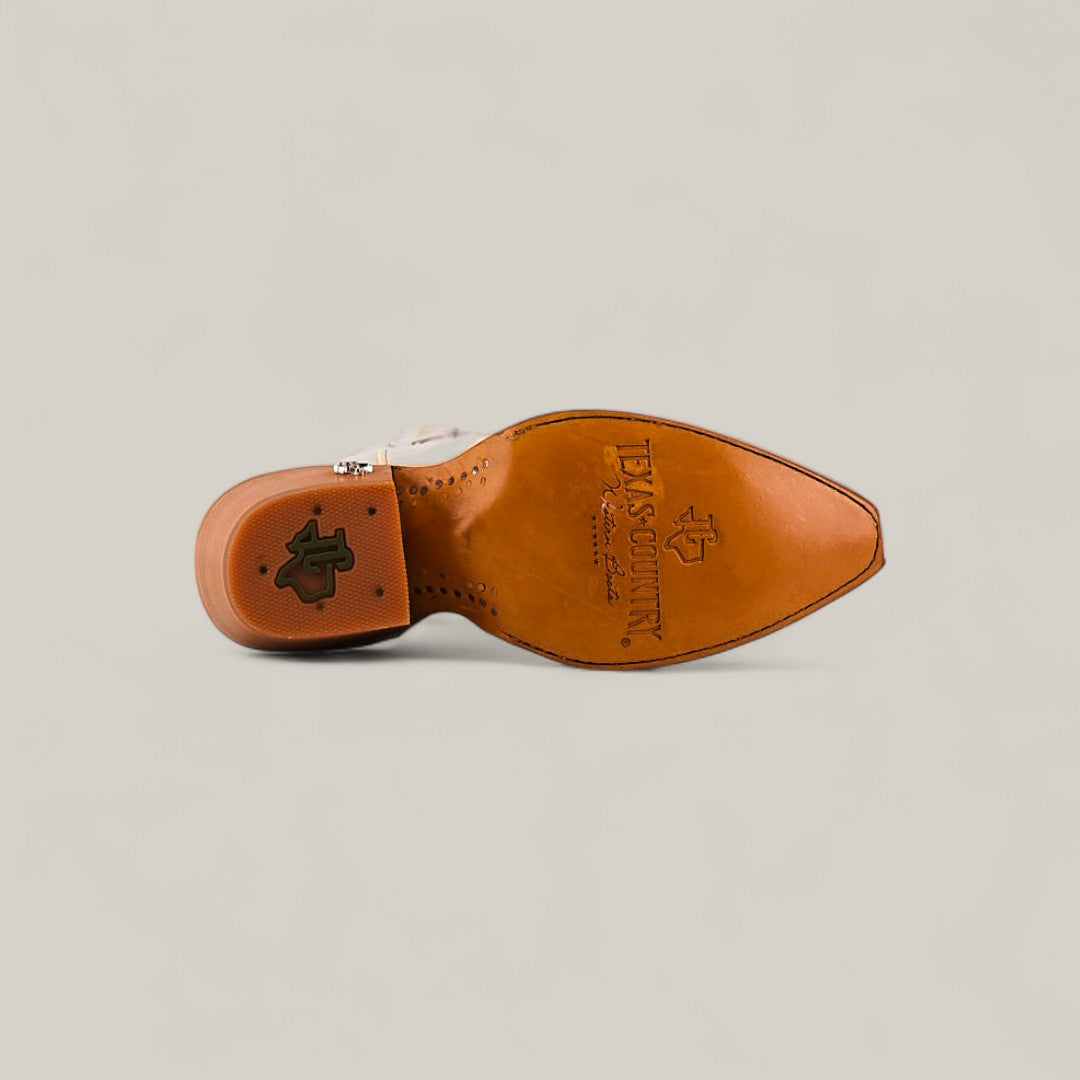 The image shows the sole of the Kellie Frost White Leather Sole boot with a tall shaft and snip toe, featuring embossed TEXAS COUNTRY branding and logo. The white boot is set against a plain, light beige background.