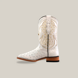 The exotic Full Quilt Ostrich boot in white, with gold embroidery and a unique textured design, is set against a light beige backdrop. It features a wooden heel and square toe, highlighting its craftsmanship.