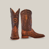 A pair of Exotic Python boots in Rustic Cogñac stand out on a light background, showcasing intricate, textured patterns. One boot is upright, displaying detailed embroidery, while the other is angled to highlight its ornate design and square toe.