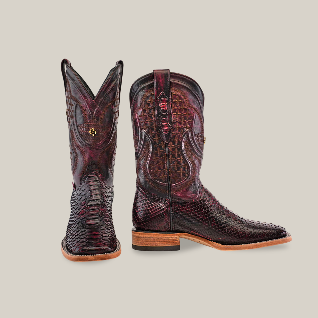 The Exotic Python - Black Cherry boots feature a dark red and black snakeskin leather design. The left boot displays the square-toed front with elegant stitching, while the right boot is shown rotated to reveal a side view with a wooden heel.