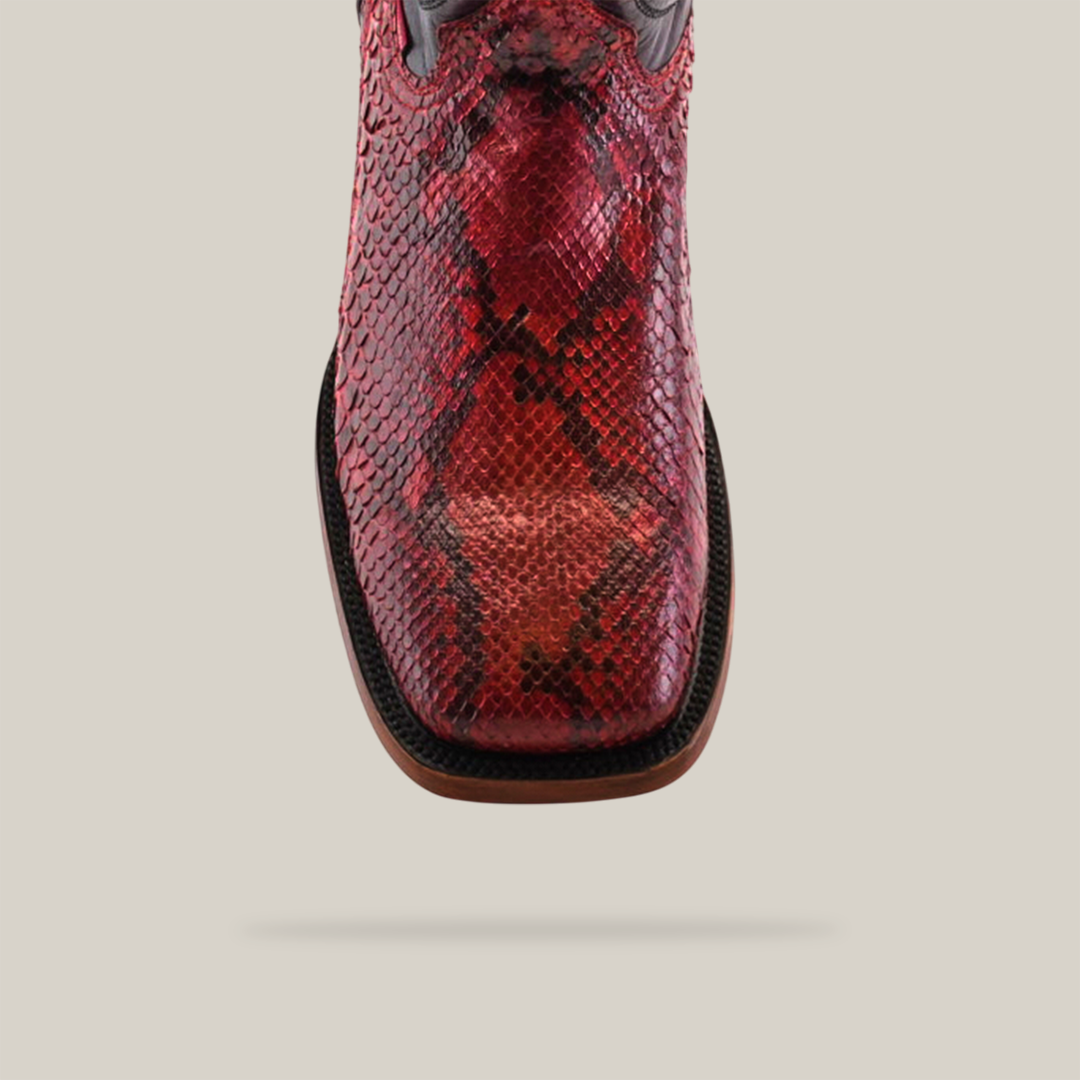 The Exotic Python - Ruby - Square Toe boot features luxurious python leather in a vibrant red snakeskin texture, complemented by a square toe and light-colored sole, styled against a neutral backdrop for bold effect.