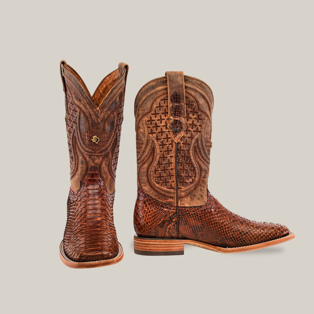 These intricately designed Exotic Python cowboy boots in brown feature rich python leather and detailed stitching, with the left boot upright and the right boot angled to display the side, heel, and signature square toe.