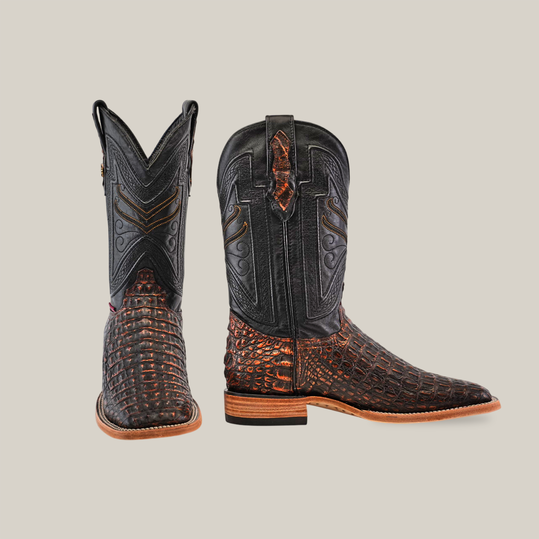 The Exotic Caiman Horn Back - Roma boots feature dark brown leather with an exotic caiman texture on the foot and lower shaft, intricate lighter stitching on the upper shaft, one forward-facing square toe boot, one side-facing boot, and light tan soles with stacked heels for a classic Western look.