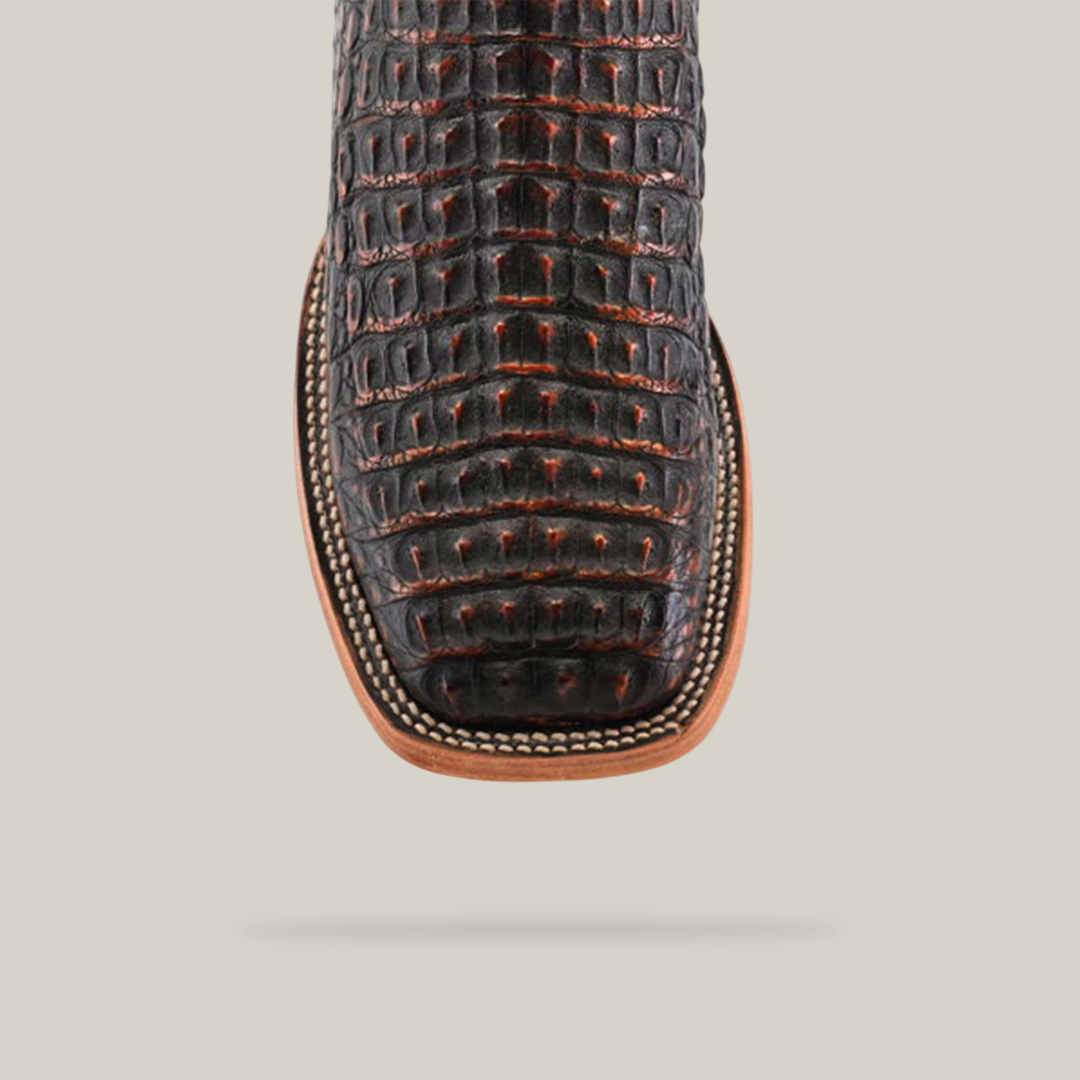 The Exotic Caiman Horn Back - Roma features a square toe with intricate stitching, crocodile-like pattern, and a light brown sole. Ideal for any Western wardrobe, it is showcased against a plain, light background.