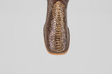 A close-up of the Tanner – Dune – Square Toe boot showcases its shiny python leather finish and detailed stitching on the toe, set against a plain white background—ideal for fans of western-inspired boots.