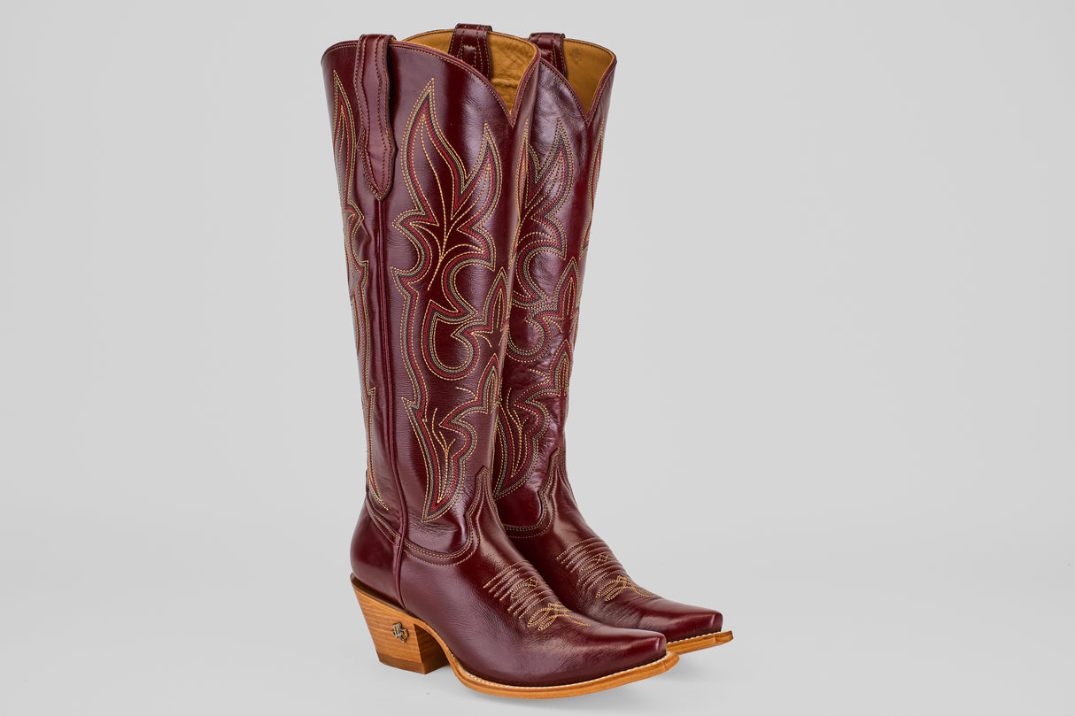 The Allison Blackberry - Tall Shaft - Snip Toe boots feature maroon leather, decorative stitching, snip toes, and light brown stacked heels, displayed on a plain light background.