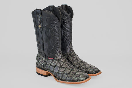 The Conor - Charcoal - Square Toe men's cowboy boots feature black fish leather uppers, textured grayish scales, light brown wooden soles, and intricate shaft stitching.