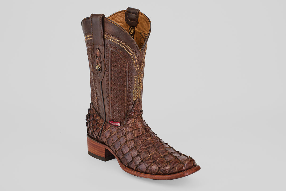 The Conor - Brown - Narrow Square Toe boot features brown fish leather with a textured, scale-like pattern, decorative shaft stitching, and a stacked wooden heel, shown against a plain white background.