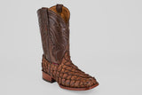 The Conor - Brown - Rodeo Toe boot features brown pirarucu leather with scale-like texture, decorative stitching on the shaft, a square rodeo toe, and a wooden heel, showcased against a light gray background.