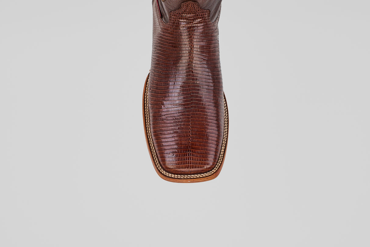 A close-up, top-down view of the toe of the Blaze – Brown – Square Toe boot showcases lizard-textured leather and decorative stitching, highlighting the rugged elegance of this classic western style.
