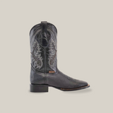 The Cheyenne Black - Square Toe boot features premium cowhide, intricate stitching, and a pointed toe. Displayed against a white background, this handcrafted accessory boasts a low heel and exudes elegance.