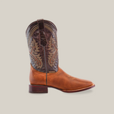 A single cowboy boot from the Cater Honey - Square Toe collection, expertly crafted from premium cowhide. It features a brown leather lower and intricately stitched darker upper, showcasing artisan skill with a low heel and pointed toe, set against a plain white background.