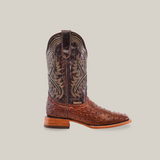 The Karoo Ostrich Print Chocolate cowboy boot features intricate stitching on the leather shaft, a square toe, and a wooden heel. Displayed against a white background, it showcases its unique design and craftsmanship.