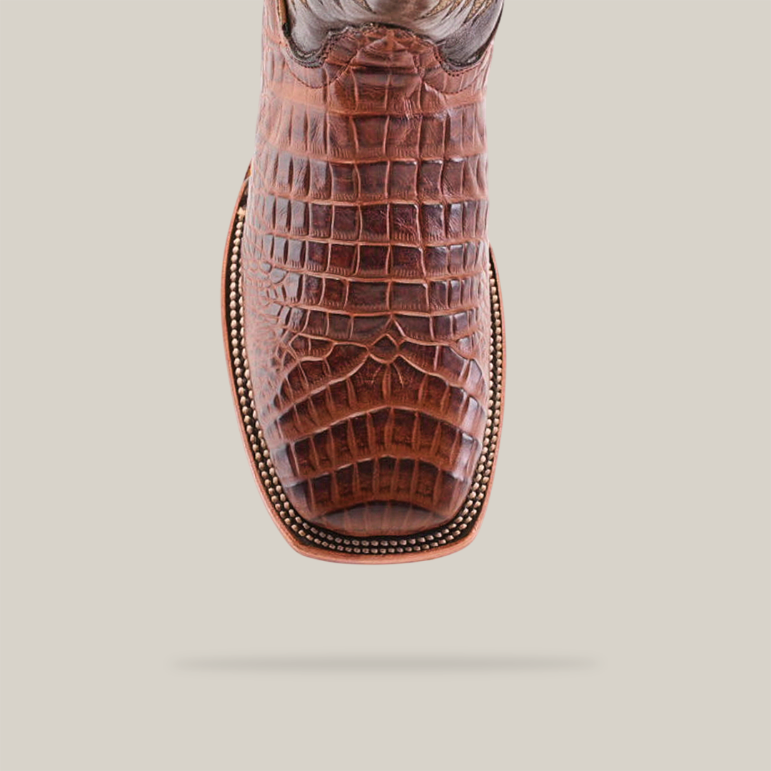 Top view of a Chocolate Caiman Belly Print cowboy boot with a square toe. This exquisite handmade piece features detailed stitching and decorative beading, showcasing craftsmanship at its finest.