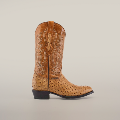 The Karoo Ostrich Print Orix - Round Toe boot boasts a light brown ostrich print texture with intricate lighter stitching, a short heel, leather sole, and convenient pull strap, displayed on a plain white background