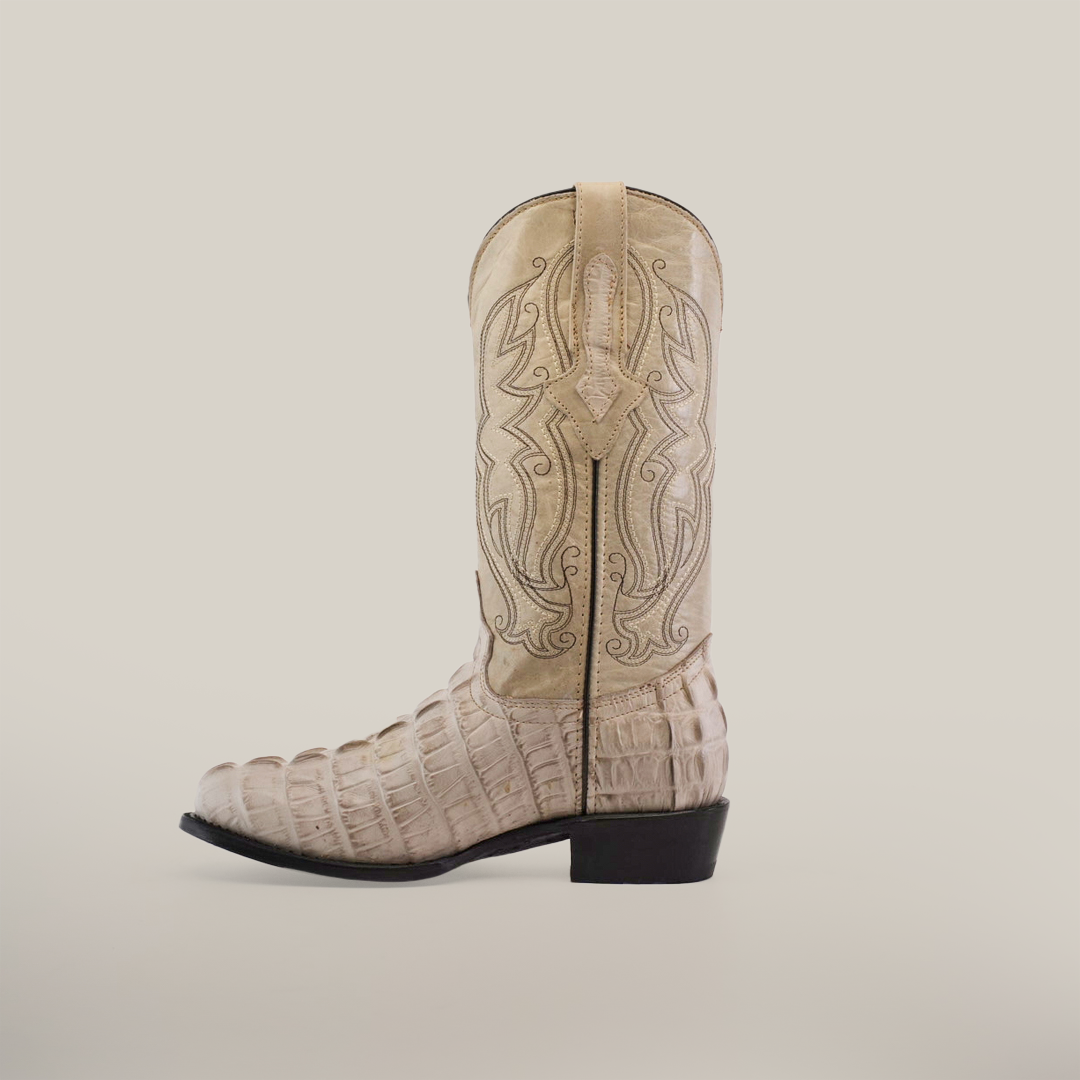 The Crocodile Tail Print Bone - Round Toe cowboy boot in beige showcases a textured crocodile tail print on the lower part and intricate shaft stitching, highlighting premium cowhide craftsmanship. Its timeless style and quality shine against a plain white background.