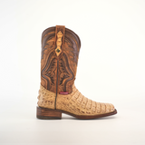 The Exotic Caiman Hornback - Orix - Rodeo Toe is a handcrafted cowboy boot made from premium leather with intricate brown designs and a tan textured lower mimicking Caiman skin, featuring a wooden heel and small red tag near the ankle, displayed against a plain white background.