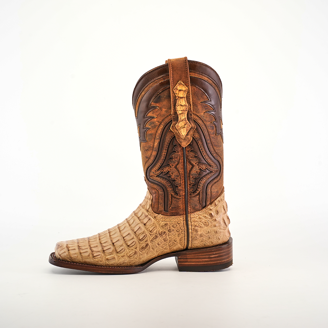 The Exotic Caiman Hornback - Orix - Rodeo Toe is a single cowboy boot made from premium leather featuring a light tan lower with textured design, darker brown intricate stitching on the upper, a decorative pull strap, and a low stacked heel in handcrafted quality.