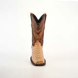 The Exotic Caiman Hornback - Orix - Rodeo Toe is a single cowboy boot made from premium leather, showcasing a light tan, textured lower and a darker brown, intricate design on the upper shaft against a plain white background.