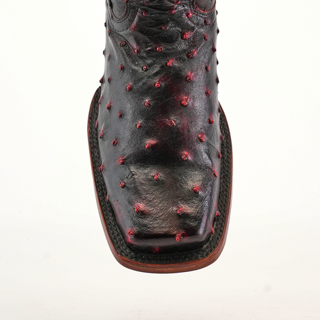 Close-up of an Exotic Ostrich - Black Cherry boot featuring a Rodeo toe, intricate red dot embellishments, and detailed stitching on black ostrich leather, set against a plain white background.