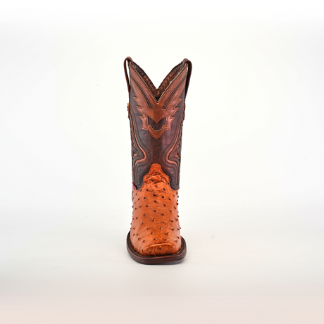 A single Exotic Ostrich - Brandy cowboy boot stands upright on a neutral background, displaying its expertly crafted ostrich leather with a textured finish, intricate stitching, and pointed rodeo toe, embodying exceptional craftsmanship.