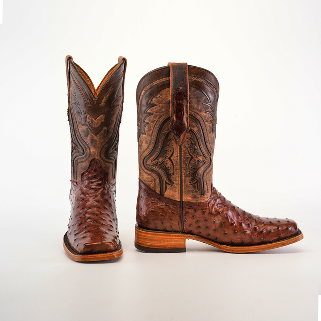 The Exotic Ostrich - Brown - Rodeo Toe cowboy boots showcase intricate patterns on ostrich leather shafts and textured feet. Positioned against a plain white background, one boot is displayed from the side and the other from the front, highlighting their superior craftsmanship.