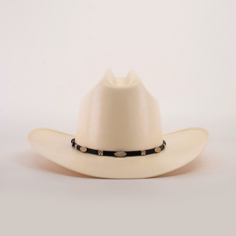 The 1000X Dos Carnales Straw Hat is a white cowboy hat with a wide brim and a black band adorned with silver conchos, crafted with exceptional quality. It stands out against a light background, proudly showcasing its superior craftsmanship.