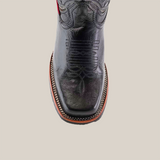 Top view of the Barcelona Black cowboy boot, crafted from premium cowhide. It features intricate stitching on the rodeo toe, complemented by a brown sole and decorative trim, all reflecting exquisite handcrafted detailing.