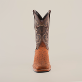 The Karoo Ostrich Roughout Print Cogñac cowboy boot is shown upright on a white background, featuring a brown cowhide with floral patterns on the shaft and an Ostrich Roughout Print toe, blending smooth and spotted leather in a striking design.