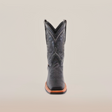 The Cheyenne Black boot with a Rodeo Toe, made from premium cowhide leather, showcases intricate front stitching on a white background. It features a brown slip-resistant sole for style and practicality.