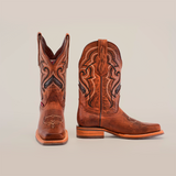 A pair of Fresno Shedron cowboy boots crafted from brown cowhide leather, featuring intricate black and tan embroidery on the shaft. They have a rodeo toe, slip-resistant sole, and stacked heel, all elegantly displayed against a plain white background.