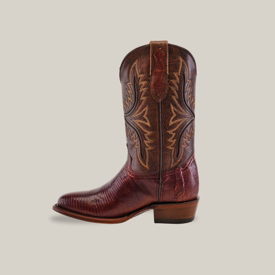 The brown exotic lizard cowboy boot features round toes, intricate tan stitching on the shaft, and a stacked heel, set against a plain white background.