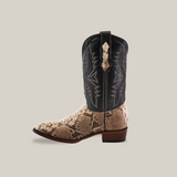 The Exotic Python - Natural - Round Toe cowboy boot showcases intricate black stitching on the shaft and a genuine textured python skin pattern on the lower part. It features a round toe, small heel, and pull strap, set against a plain beige background.