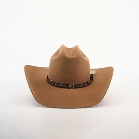 The 6X Doble SS Fawn is a brown felt cowboy hat with a dark leather band, decorative conchos, and a small feather on the side, displayed on a plain white background.