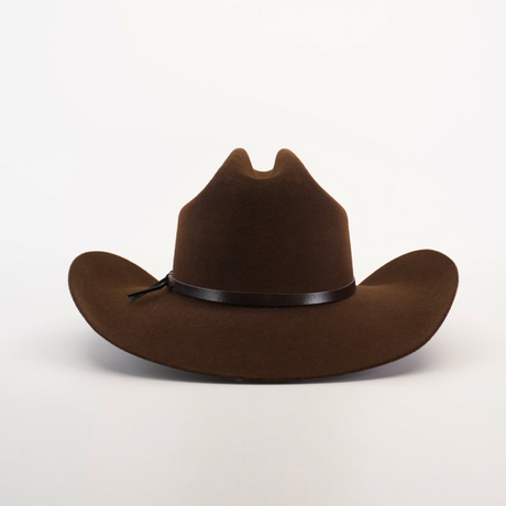 A 6X Dallas Brown felt cowboy hat with a wide brim and black band rests against a white background. It features a crown crease, exuding Western sophistication typical of cowboy hats.