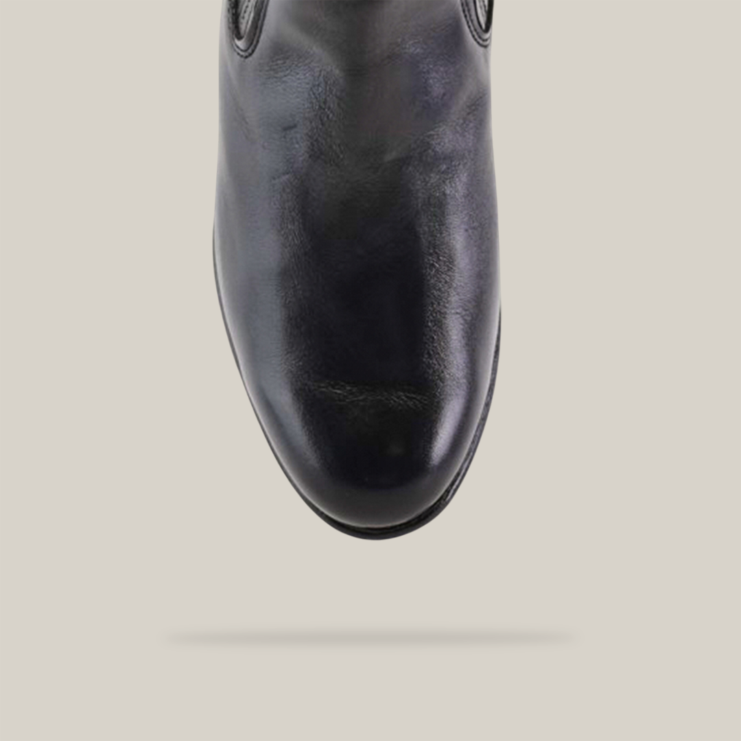 A top view of Napa Black - Round Toe, a shiny black leather shoe with cowboy-inspired fashion, set against a plain light background. The polished finish features visible stitching details around the upper edges and a rounded toe.