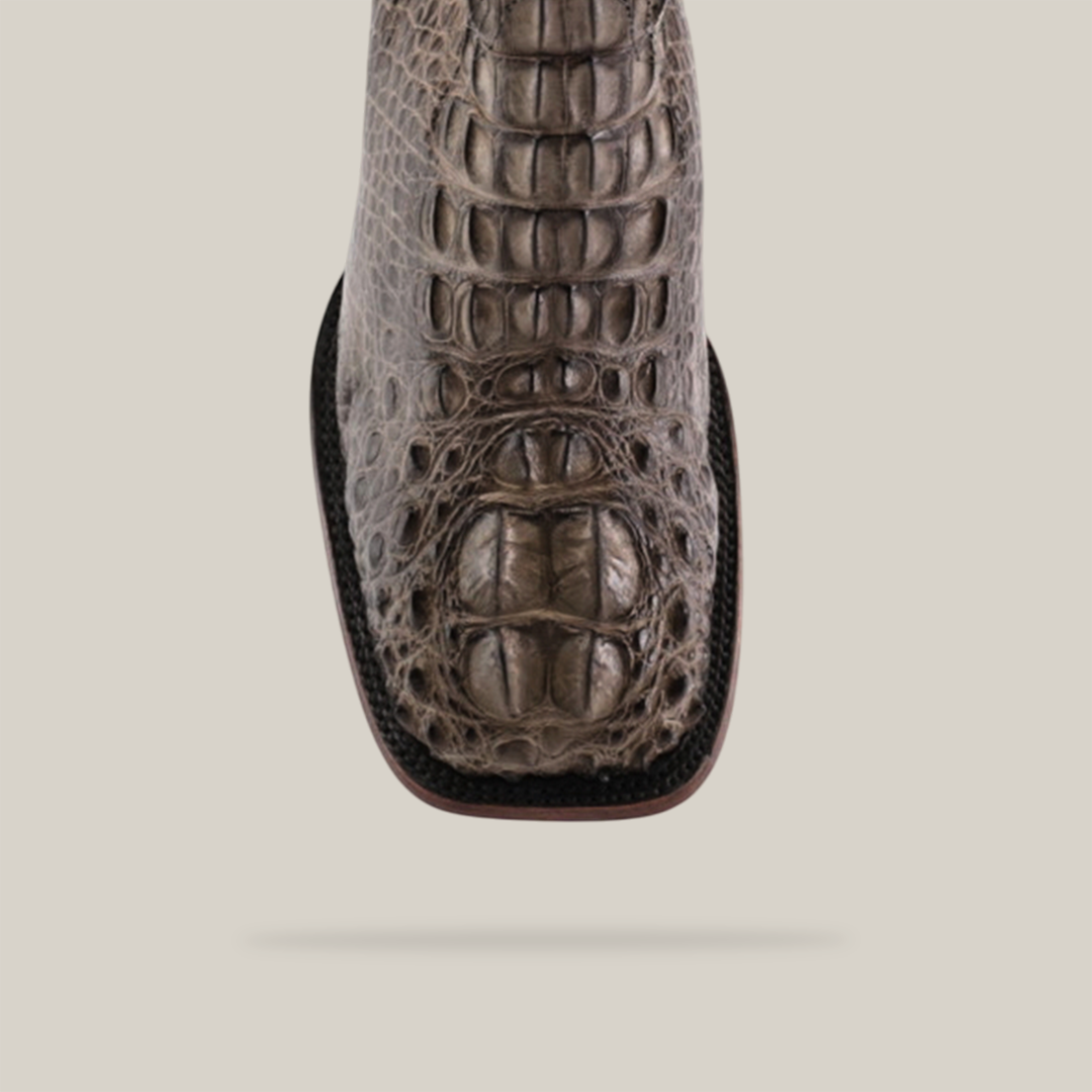 Close-up of an Exotic American Alligator Head - Gray - Square Toe boot, highlighting the intricate leather texture and pattern. The sole is visible on a plain light background, epitomizing luxury.