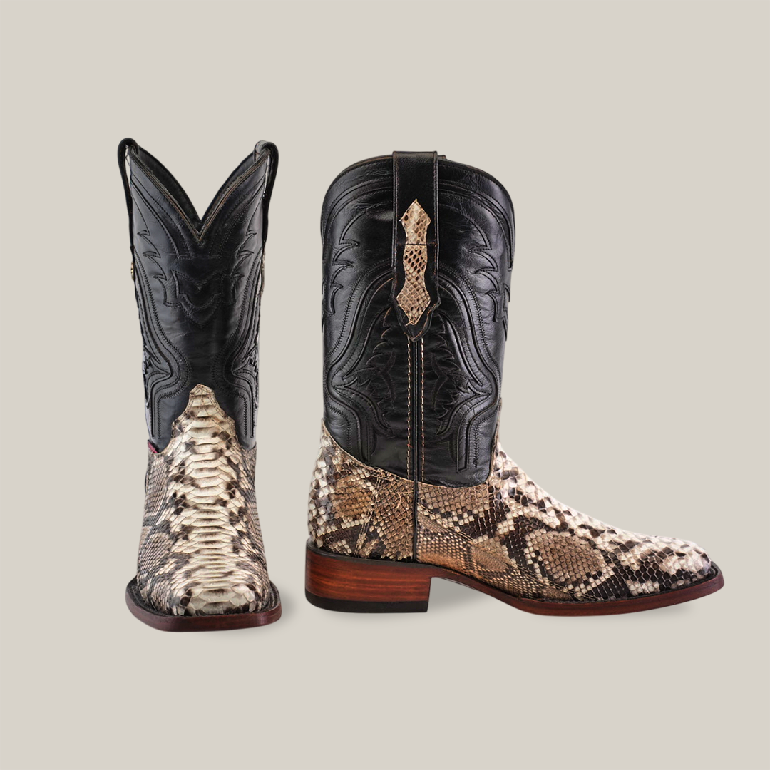 A pair of Exotic Python - Natural - Rodeo Toe luxury cowboy boots, styled with black leather shafts featuring intricate stitching, brown python-patterned leather on the lowers, and wooden heels, one facing forward and the other to the side.