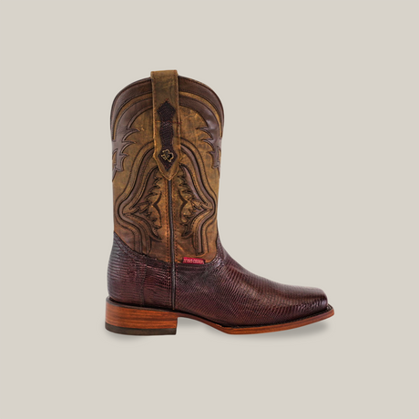 The Brown Exotic Lizard Rodeo Toe cowboy boot, featuring intricate stitching and a unique lizard pattern, is handcrafted with a wooden sole and mid-height heel. It sits against a plain backdrop, highlighting its smooth to slightly rough textures.