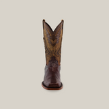 Front view of the Exotic Lizard - Brown - Rodeo Toe, a handcrafted cowboy boot, featuring intricate shaft stitching and authentic lizard skin detail against a plain beige background.