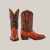 A pair of ornate Exotic Full Quilt Ostrich - Brandy - Round Toe boots, crafted from rich brown and orange ostrich leather. One boot stands upright, the other is angled, highlighting meticulous stitching and design on a neutral background—exemplifying exquisite craftsmanship.