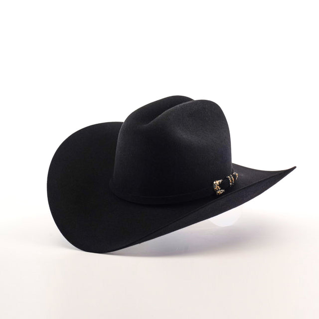 The 10X Jerarca Black hat, a fur felt cowboy style with a wide brim and decorative band adorned with metal accents, epitomizes handcrafted western headwear and is displayed against a plain white background.